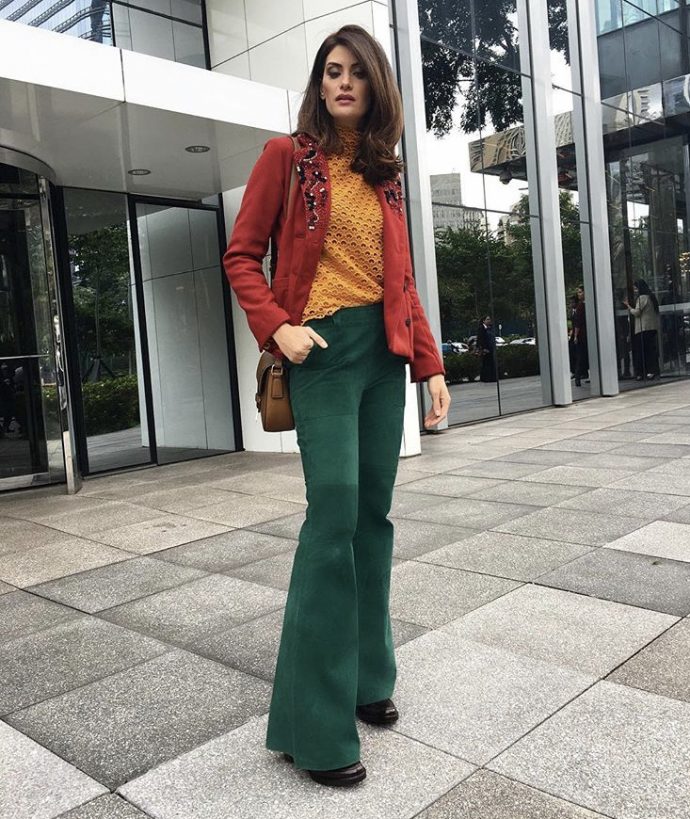 Isabella Fiorentino usa casaco vermelho blusa amarela e calca verde